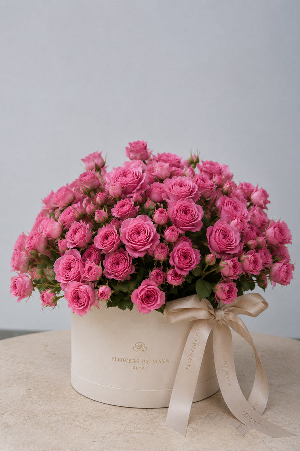 Pink Spray Rose Hat Box by Flowers By Maya, bright pink spray roses in a cream suede hat box with champagne ribbon