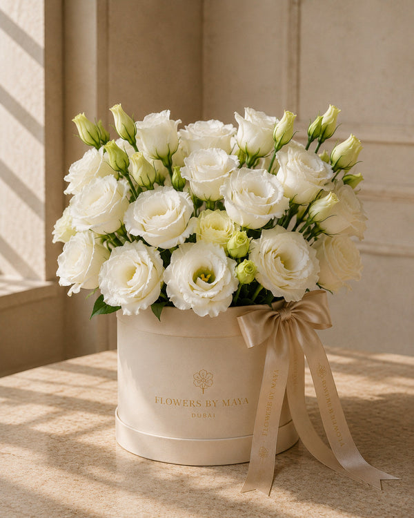 White Lisianthus Hat Box by Flowers By Maya, ruffled white lisianthus with green buds in a cream suede hat box