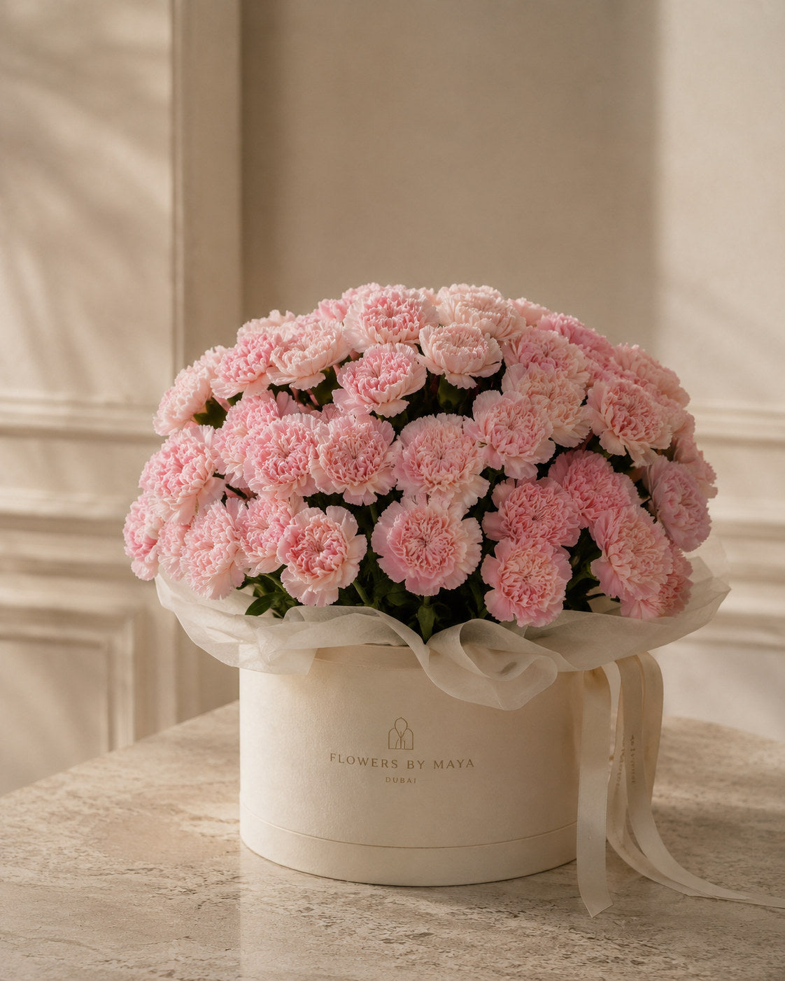 Pink Carnation Hat Box by Flowers By Maya, soft pink carnations in a cream suede hat box with ivory tissue