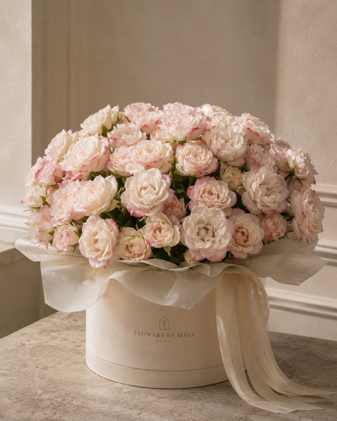 Ivory Romance by Flowers By Maya, blush and ivory garden spray roses in a cream suede hat box